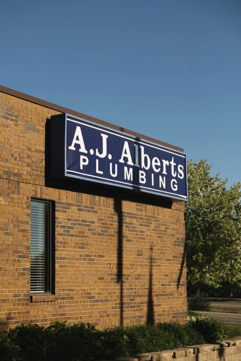 The A.J. Alberts Plumbing showroom at 7975 Afton Road in Woodbury, Minnesota, identifiable by the blue and white building sign